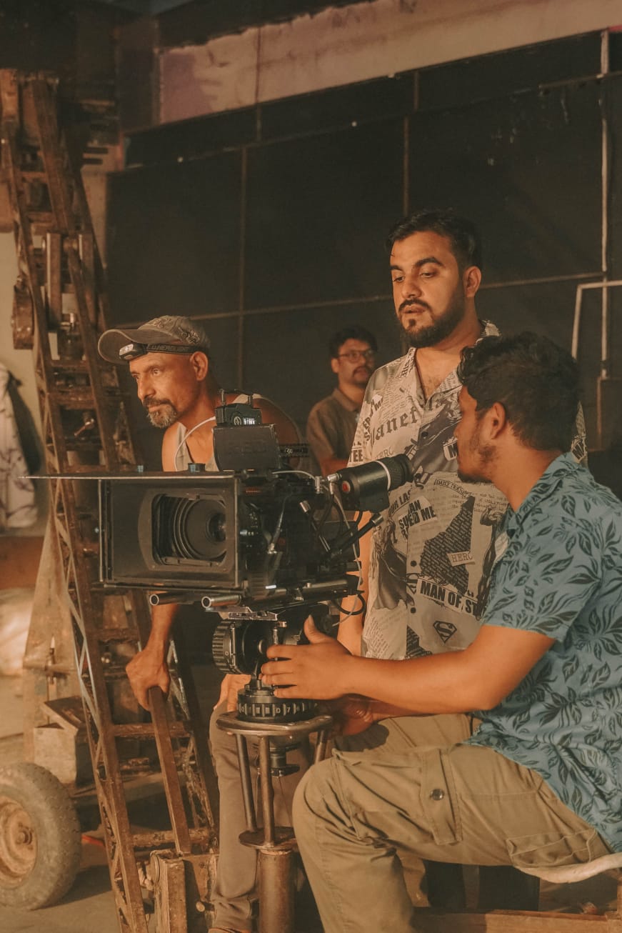 Robin and a film crew working together around a cinema camera