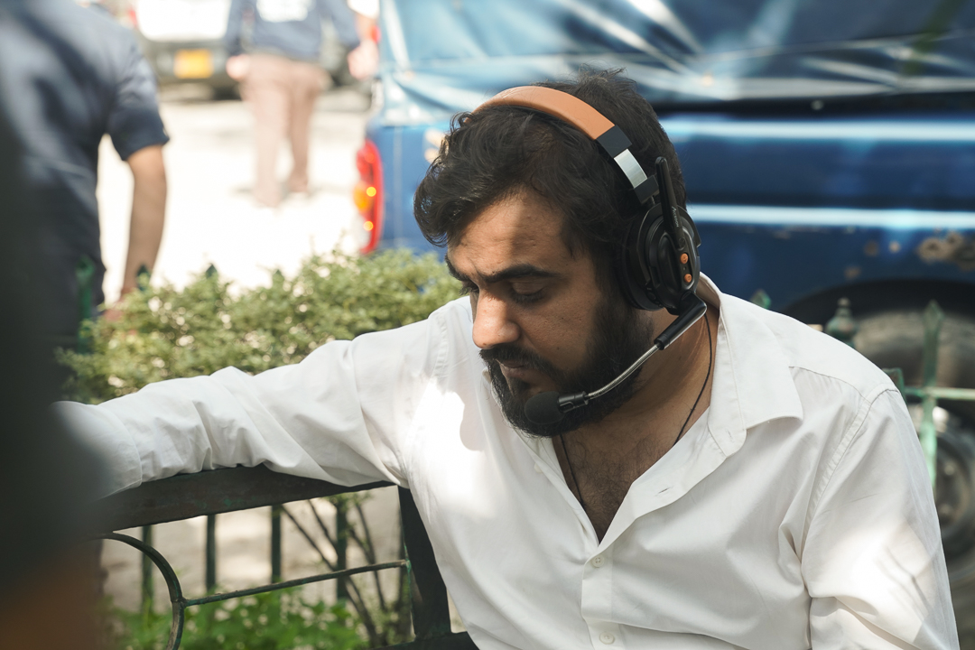 Robin wearing a headset while working on set